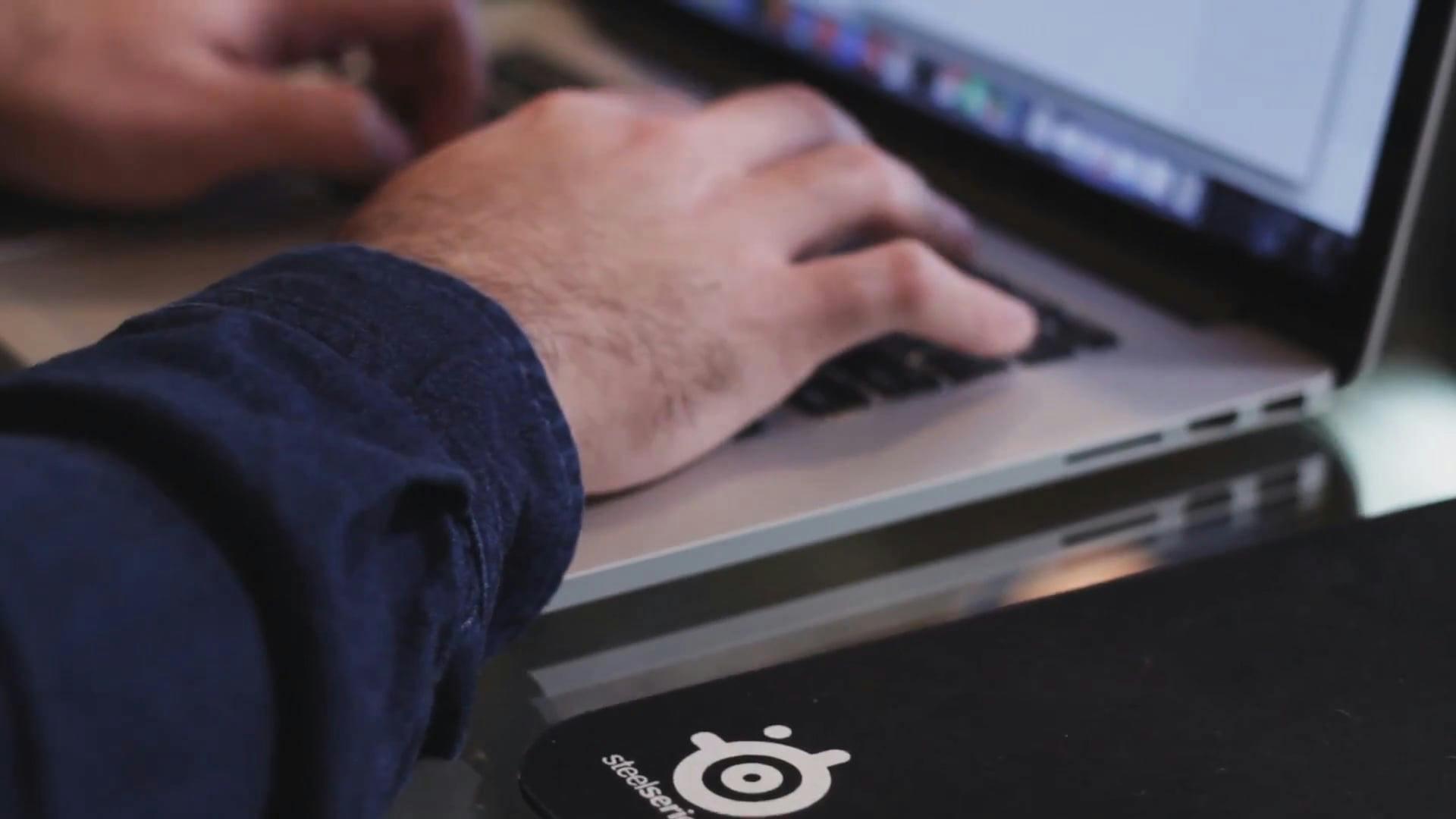 Close-Up Of Hands Typing On A Laptop In A Tech Environment.