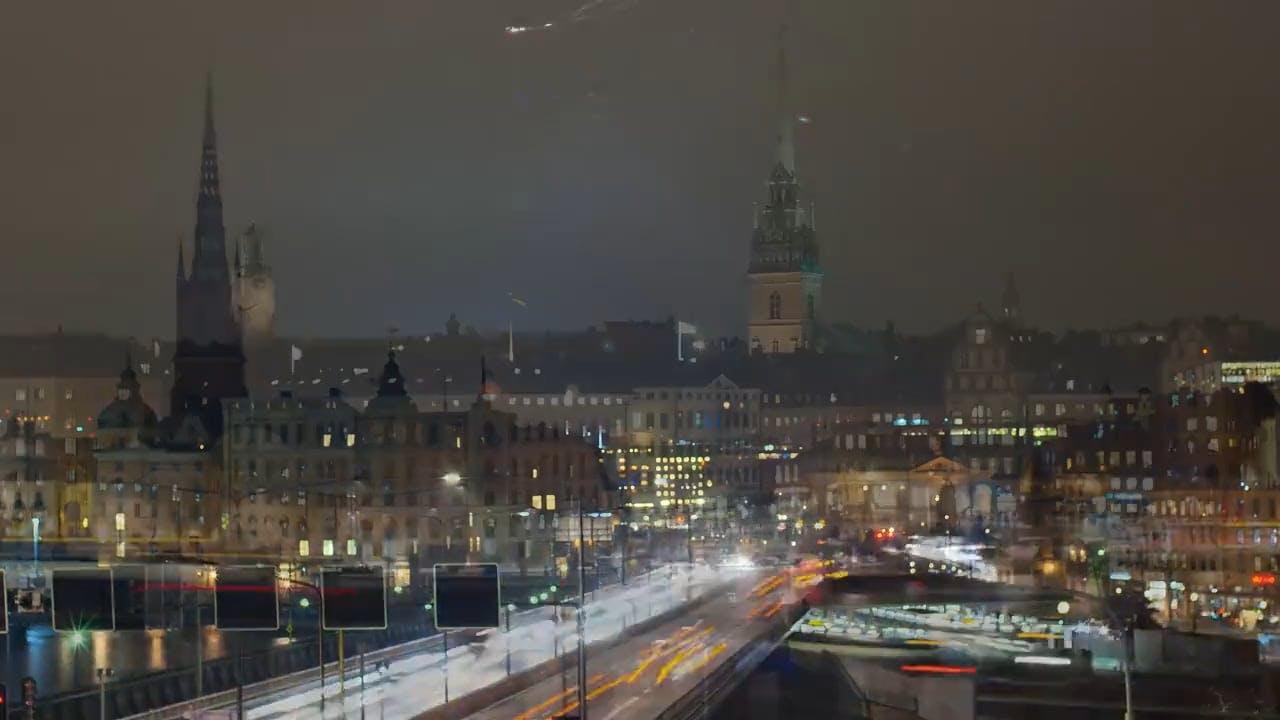 Explore The Vibrant City Lights And Bustling Night Traffic Of Stockholm.