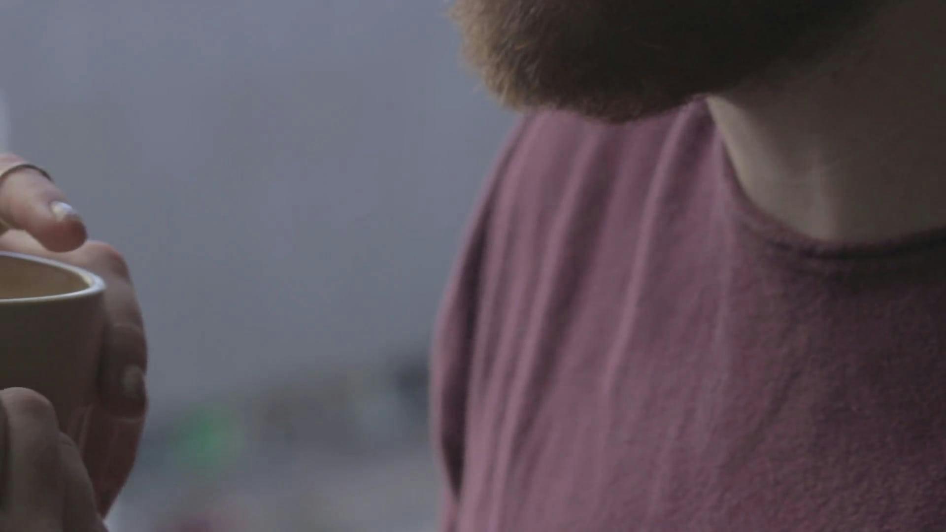 Intimate Scene Of A Couple Sharing A Warm Beverage In A Cozy Setting.