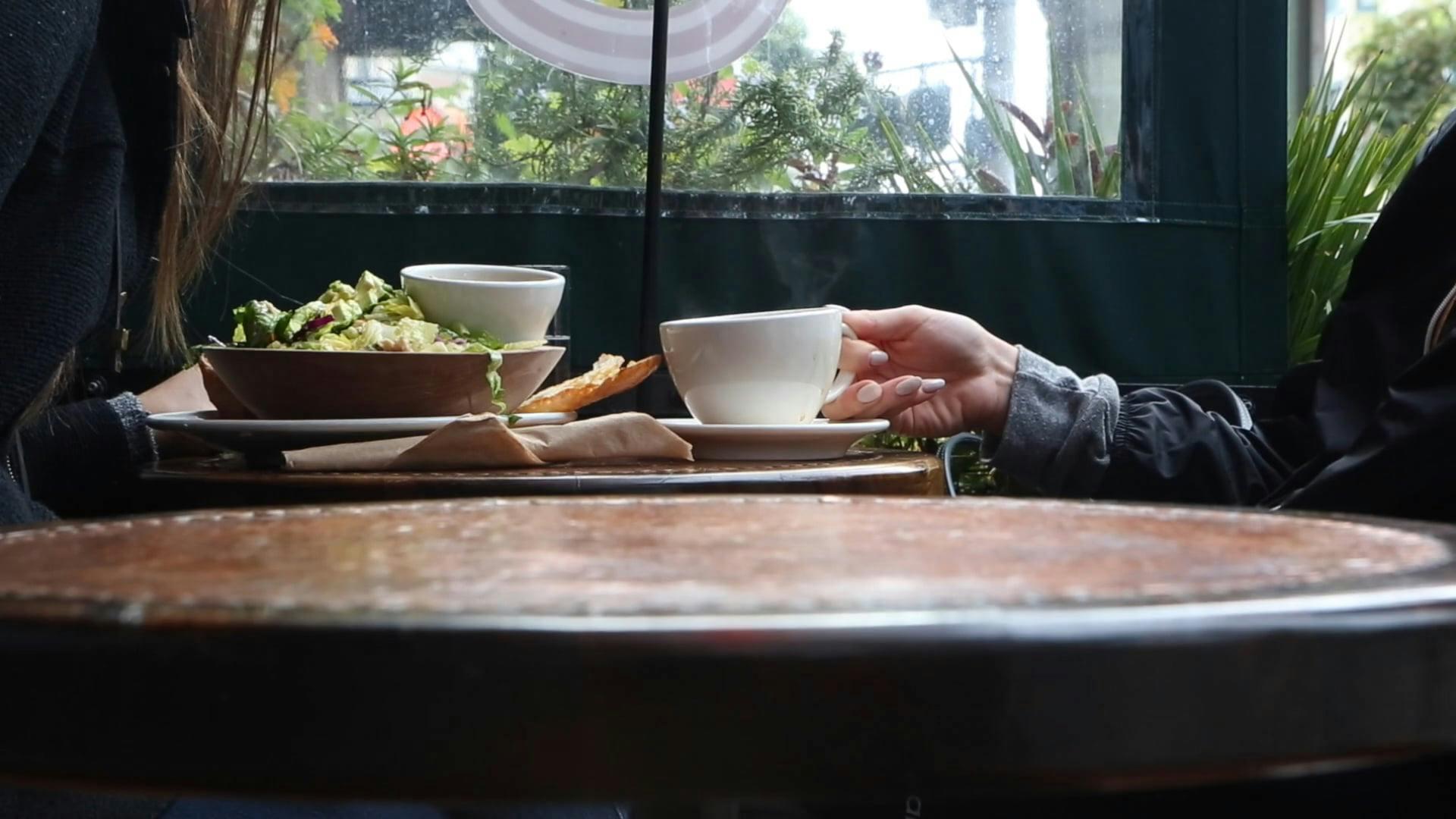 People Enjoying Meals And Coffee At A Cozy Urban Cafe.